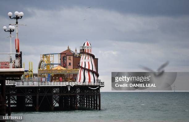 Gul flies near Brighton Palace Pier in Brighton, southern England December 6, 2021. "An open sewer", is how surfer Stu Davies described the waters...