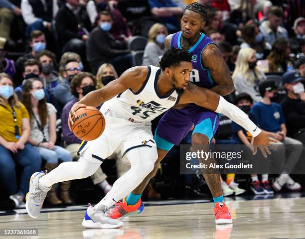 Donovan Mitchell of the Utah Jazz drives into Terry Rozier of the Charlotte Hornets in the second half of a game at Vivint Smart Home Arena on...