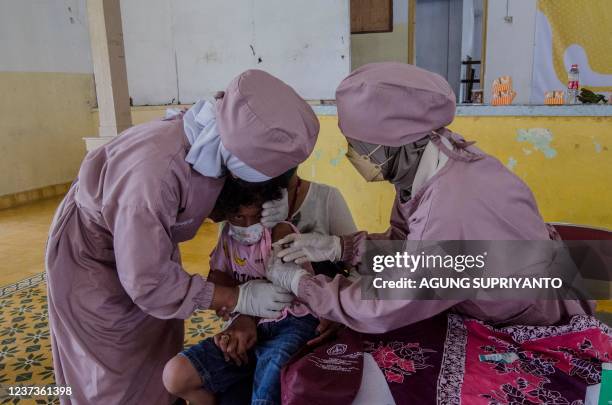 Child receives a Sinovac vaccine against Covid-19 coronavirus in Yogyakarta on December 21, 2021.