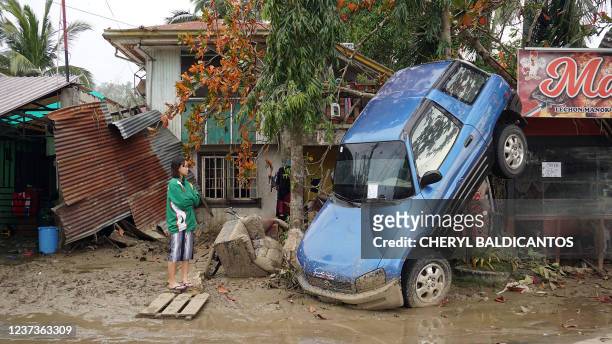 Resident looks at a vehicle swept away due to floodings brought about by super Typhoon Rai in Loboc town, Bohol province on December 21, 2021.