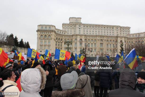 People gather outside Romanian Parliament to protest against Covid-19 vaccine and health card in Bucharest, Romania on December 21, 2021. The protest...