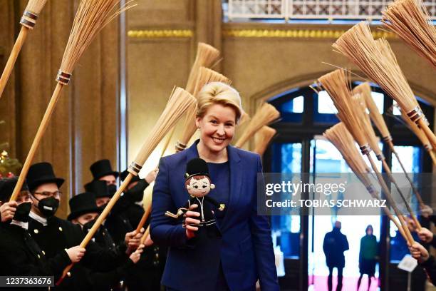New Governing Mayor of Berlin Franziska Giffey holds a welcome present from the chimney sweepers after arriving to the Berlin city hall in Berlin,...