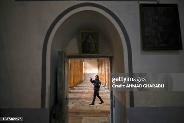 Member of security staff walks inside the Church of the Nativity, the traditional place of Christ's birth, ahead of Christmas in the biblical city of...