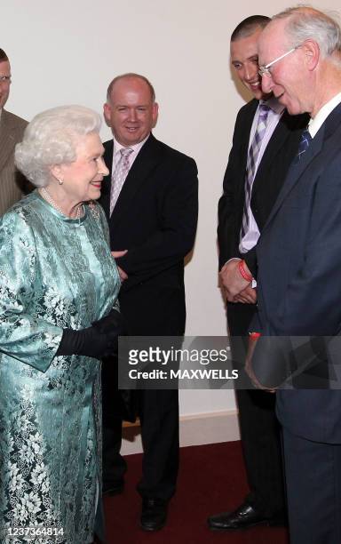 Britain's Queen Elizabeth II smiles as she meets former Irish football manager Jack Charlton as Irish Rugby Manager Declan Kidney and Kerry...