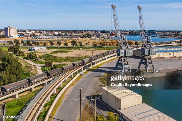rail freight grain cars crossing port river bridge, new development in background - adelaide stock pictures, royalty-free photos & images