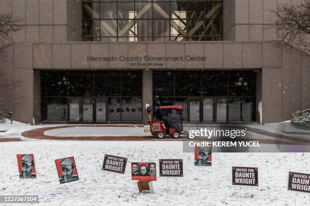 Images of Daunte Wright and signs are left outside the Hennepin County Government Center in Minneapolis, Minnesota, on December 21 during jury...