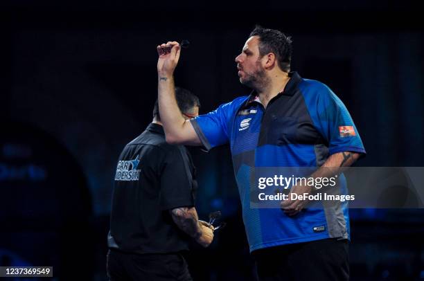 London, England, : Adrian Lewis throws a dart in the match against Gary Anderson during the PDC William Hill World Darts Championship at Alexandra...