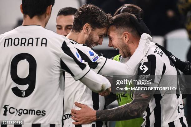 Juventus' Italian forward Federico Bernardeschi celebrates with Juventus' Italian midfielder Manuel Locatelli after scoring during the Italian Serie...