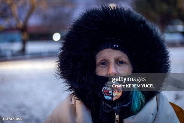 Woman wears a mask with a picture of Daunte Wright outside the Hennepin County Government Center in Minneapolis, Minnesota, on December 21 during...
