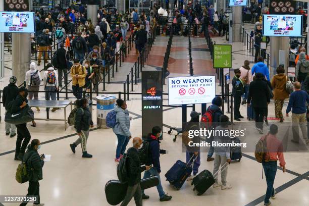 Travelers at the Hartsfield-Jackson Atlanta International Airport in Atlanta, Georgia, U.S., on Tuesday, Dec. 21, 2021. Airline passenger numbers in...