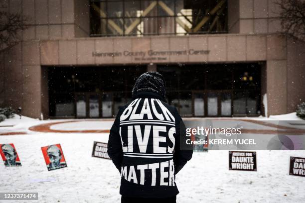 Person demonstrates in support of Daunte Wright outside the Hennepin County Government Center in Minneapolis, Minnesota, on December 21 during jury...