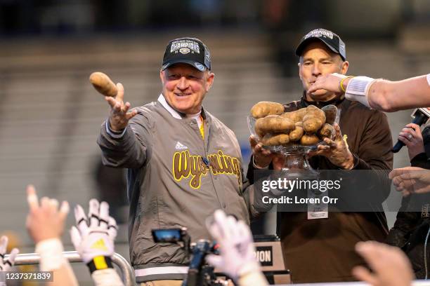 Head coach Craig Bohl and Athletic Director Tom Burman of the Wyoming Cowboys celebrate a win over the Kent State Golden Flashes at the Famous Idaho...