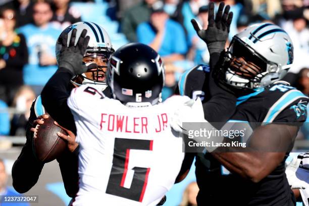 Cam Newton of the Carolina Panthers drops back to pass against the Atlanta Falcons at Bank of America Stadium on December 12, 2021 in Charlotte,...