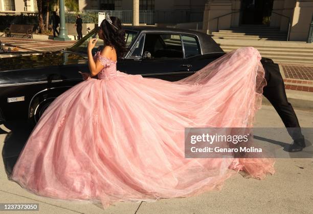 Nicole Elizabeth Rodriguez has her dress arranged by a member of her court at Pasadena City Hall where she was having photos made in celebration of...