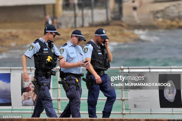 Police officers patrol on the Bondi Beach in Sydney on December 22 amid number of COVID-19 cases that keeps on the rise across the New South Wales...