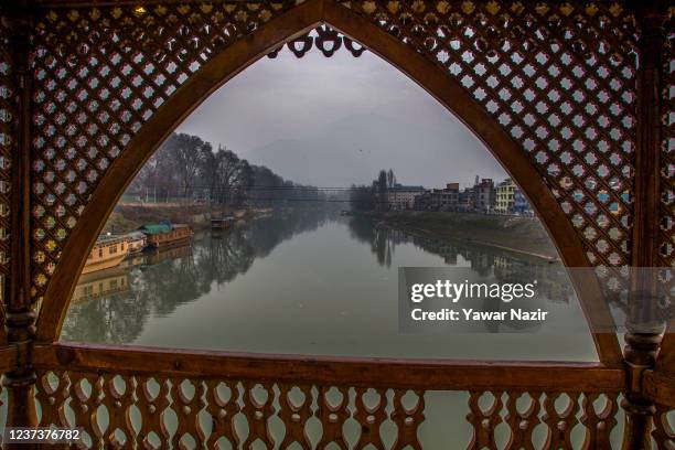 Houses boats are moored to the bank of river Jehlum, on December 22, 2021 in Srinagar, the summer capital of Indian administered Kashmir, India. The...