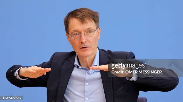 German Health Minister Karl Lauterbach gestuers as he speaks during a press conference on the situation of the coronavirus pandemic in Germany, in...