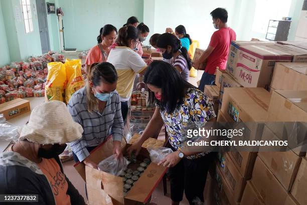 Volunteers pack relief goods for distribution in Calape town, Bohol province on December 22 days after Super Typhoon Rai devastated the province.