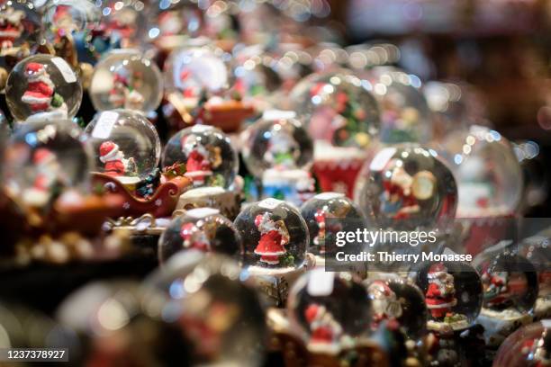 Snow globes displayed for sale at the Christmas Market under SARSCoV2 safety measures on December 21, 2021 in Aachen, Germany.