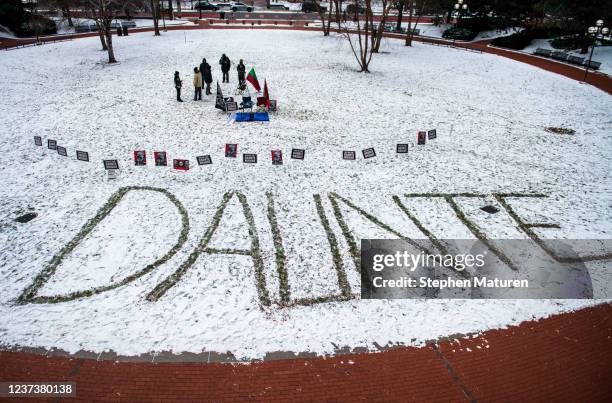 The name Daunte is spelled out in the snow as people demonstrate outside the Hennepin County Government Center on December 22, 2021 in Minneapolis,...