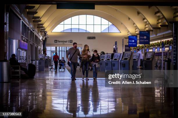 Santa Ana, CA Travelers make their way to their gate for Christmas and holiday travel, although some people cancelling or rethinking their holiday...