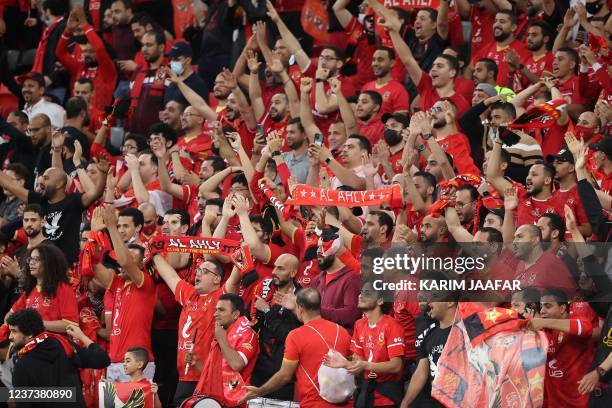 Ahly supporters cheer ahead of the CAF Super Cup football match between Egypt's Al-Ahly and Morocco's Raja Club Athletic at the Ahmad Bin Ali Stadium...