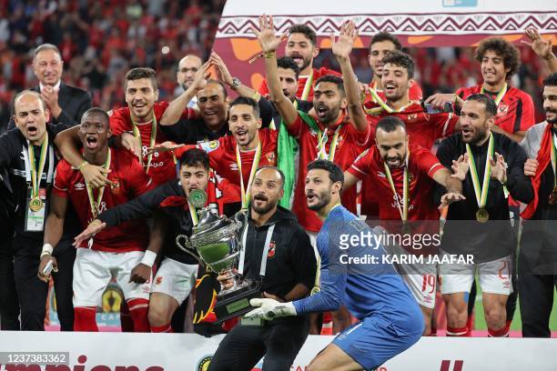 Ahly's players celebrate after winning the CAF Super Cup football match between Egypt's Al-Ahly and Morocco's Raja Club Athletic at the Ahmad Bin Ali...