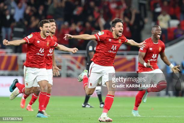Ahly players celebrate winning the CAF Super Cup football match between Egypt's Al-Ahly and Morocco's Raja Club Athletic at the Ahmad Bin Ali Stadium...