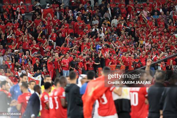 Ahly supporters cheer their team after the CAF Super Cup football match between Egypt's Al-Ahly and Morocco's Raja Club Athletic at the Ahmad Bin Ali...