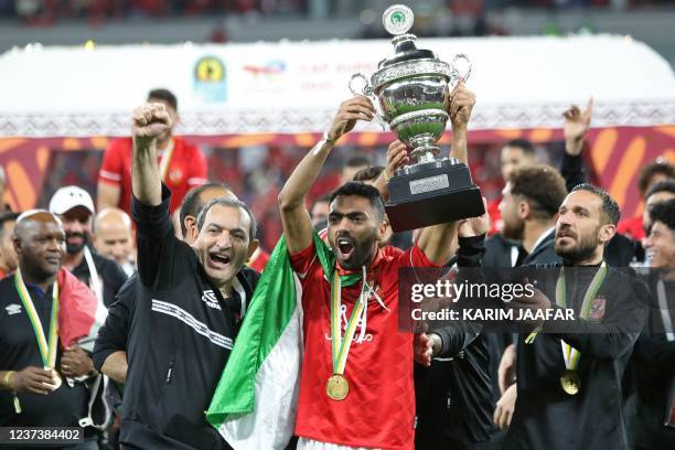 Ahly's players celebrate with the winners trophy following the CAF Super Cup football match between Egypt's Al-Ahly and Morocco's Raja Club Athletic...