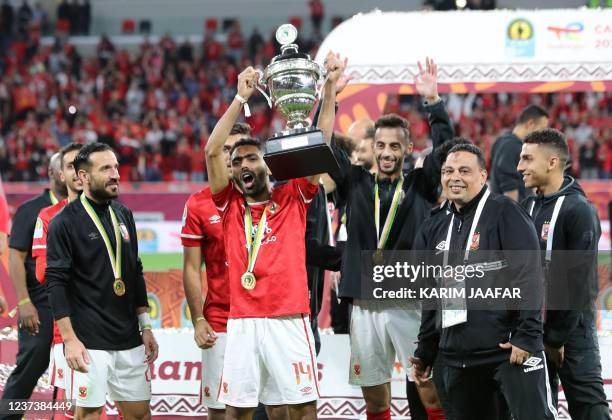 Ahly's players celebrate with the winners trophy following the CAF Super Cup football match between Egypt's Al-Ahly and Morocco's Raja Club Athletic...