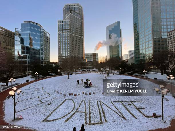 The name Daunte is written in the snow outside the Hennepin County Government Center in Minneapolis, Minnesota, on December 22 during jury...