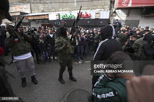 Militants of the Aqsa Martyrs' Brigades fire their guns during the funeral of Palestinian Mohammed Issa Abbas, who reportedly fired on Israeli troops...