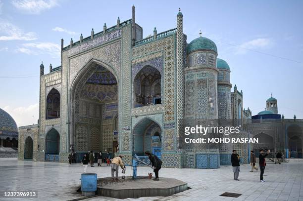 People take pictures of the Hazrat-e-Ali shrine or Blue Mosque in Mazar-i-Sharif on December 23, 2021.