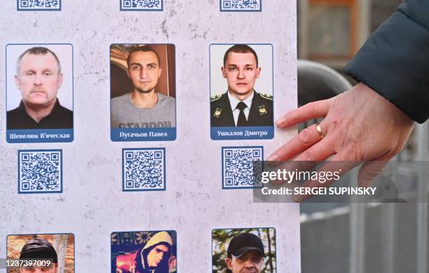 This photograph taken on December 23 shows a pictures of prisoners of war in the military conflict between Ukrainian forces and Russia-backed...