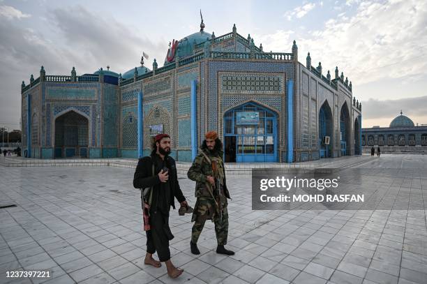 Taliban fighters walk through the compound of the Hazrat-e-Ali shrine or Blue Mosque in Mazar-i-Sharif on December 23, 2021.