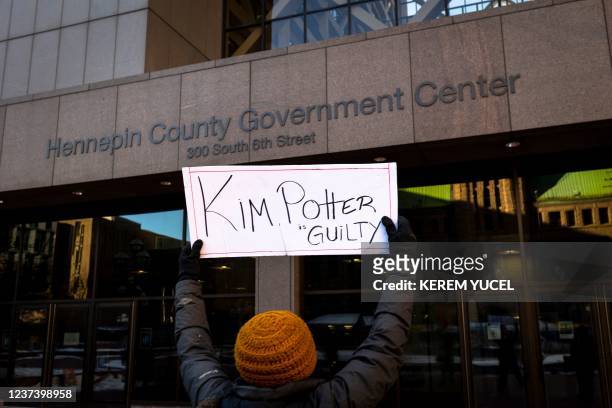 Marcia Howard, a local activist holds a sign reads "Kim Potter Guilt" outside the Hennepin County Government Center in Minneapolis, Minnesota, on...