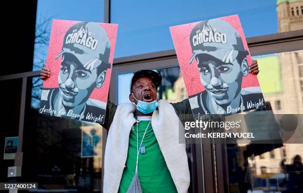 Demonstrator holds images of Daunte Wright outside the Hennepin County Government Center in Minneapolis, Minnesota, on December 23 as the verdict in...