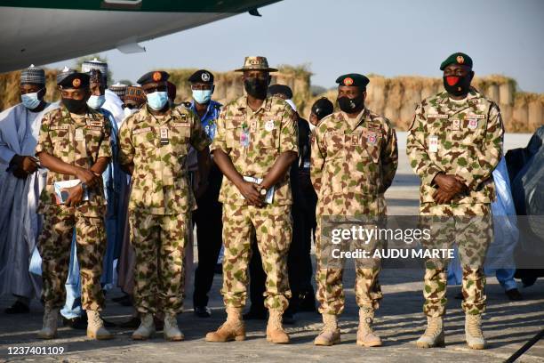 Troops of operation Lafiya Dole stands on guard as they are addressed by Nigerian President Muhammadu Buhari at the airforce base in Maiduguri on...