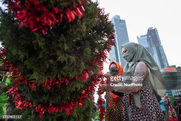 Indonesian muslim women decorate the main Christmas tree during Christmas celebration entitled Christmas Carol ahead of Christmas Eve in Jakarta on...