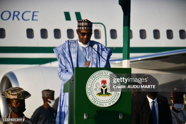 Nigerian President Muhammadu Buhari addresses troops at airforce base Maiduguri on December 23, 2021. - At least four people were killed on Thursday...