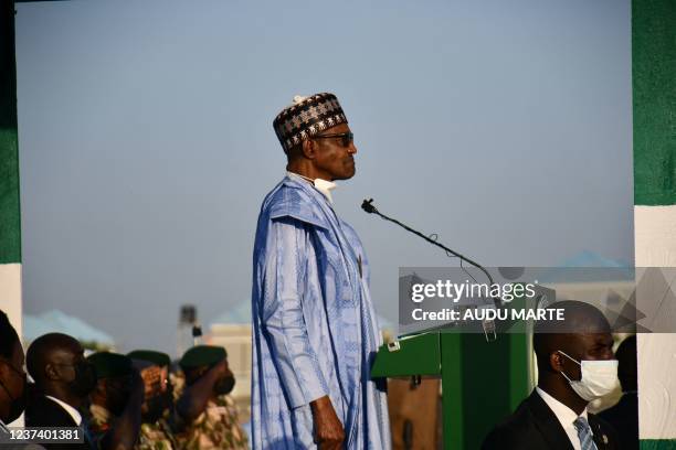 Nigerian President Muhammadu Buhari addresses troops at airforce base Maiduguri on December 23, 2021. - At least four people were killed on Thursday...