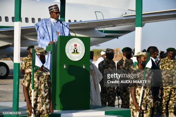 Nigerian President Muhammadu Buhari addresses troops at airforce base Maiduguri on December 23, 2021. - At least four people were killed on Thursday...