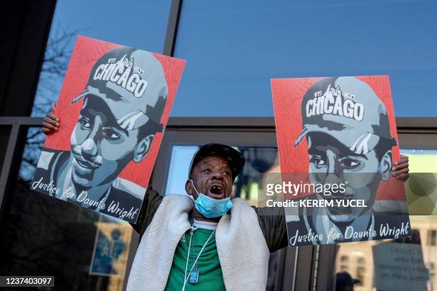 Demonstrator holds images of Daunte Wright as he waits for the verdict in the trial of former police officer Kim Potter outside the Hennepin County...