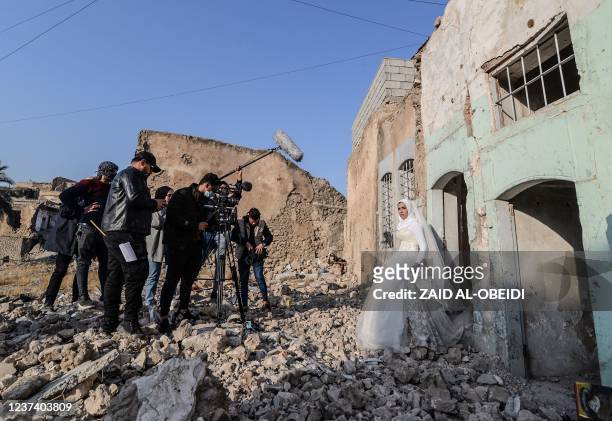 Students of a film school, work on a scene with an actress dressed as a bride, in the war-ravaged northern Iraqi city of Mosul, on December 15, 2021....