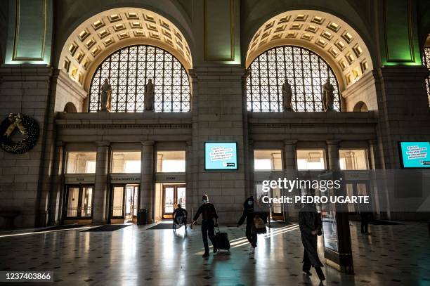 People arrive at Union Station train station in Washington, DC on December 23, 2021. - Millions of Americans were on the move December 23 during one...