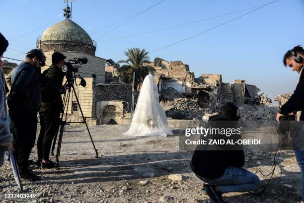 Students of a film school, work on a scene with an actress dressed as a bride, in the war-ravaged northern Iraqi city of Mosul, on December 15, 2021....