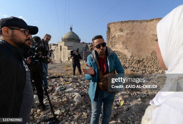 Students of a film school, work on a scene with an actress dressed as a bride, in the war-ravaged northern Iraqi city of Mosul, on December 15, 2021....