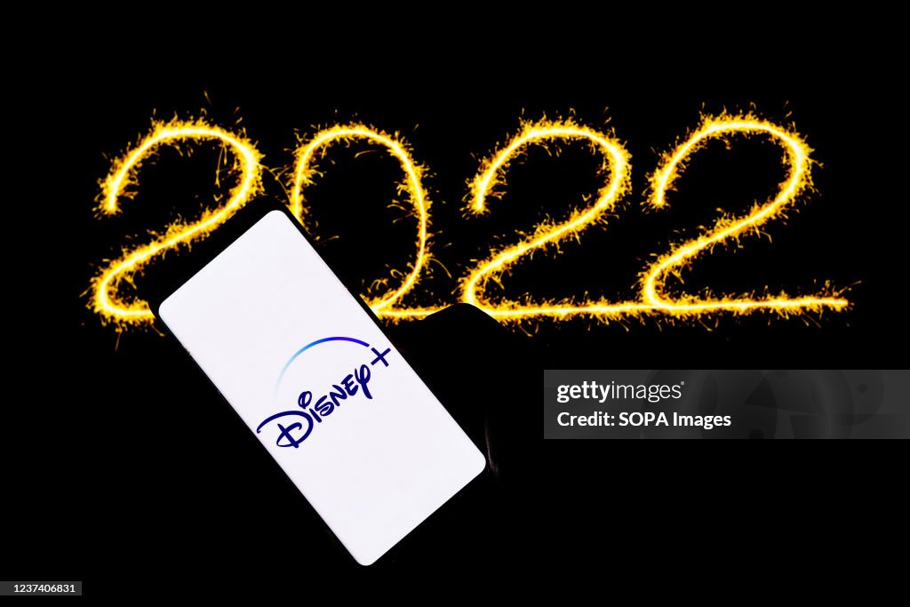 In this photo illustration a Disney Plus logo seen displayed on a