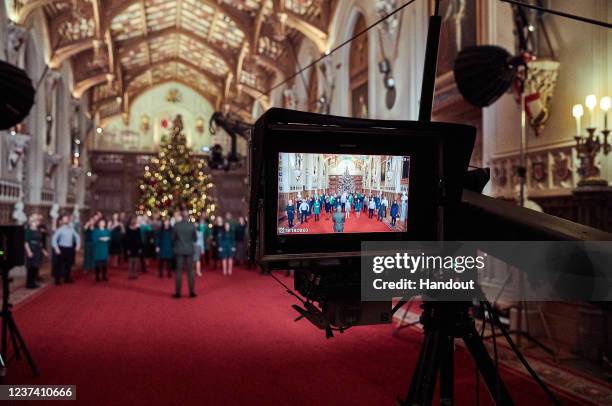In this handout image released on December 24, The Singology Community Choir record a segment for The Queen's Christmas Broadcast inside St George's...
